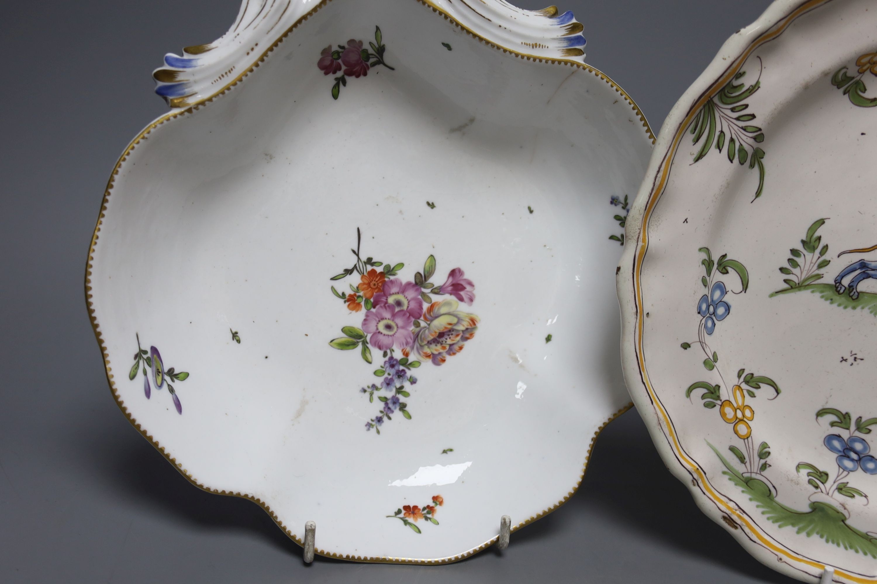 An 18th century Moustiers faience plate and a late 18th century Continental porcelain desert dish, plate 25 cms diameter.